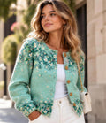 Woman wearing the sage green floral embroidered cardigan outdoors