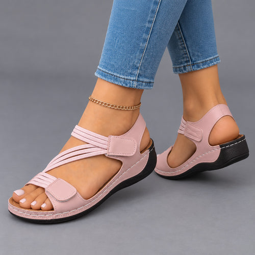 Pink comfort wedge sandals, side view on feet