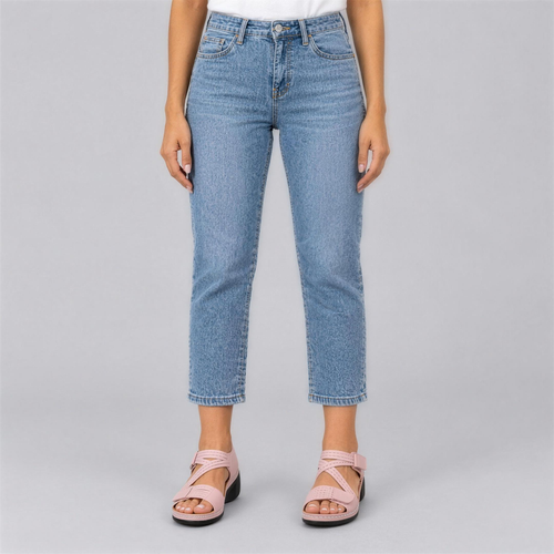 Pink comfort wedge sandals worn with cropped light jeans, studio photo
