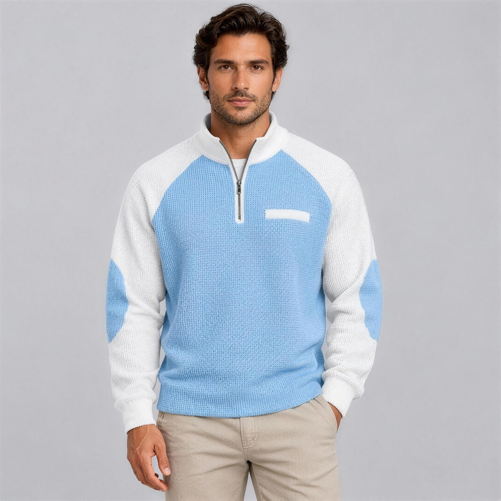Man wearing the light blue waffle knit quarter-zip pullover with chinos, studio photo