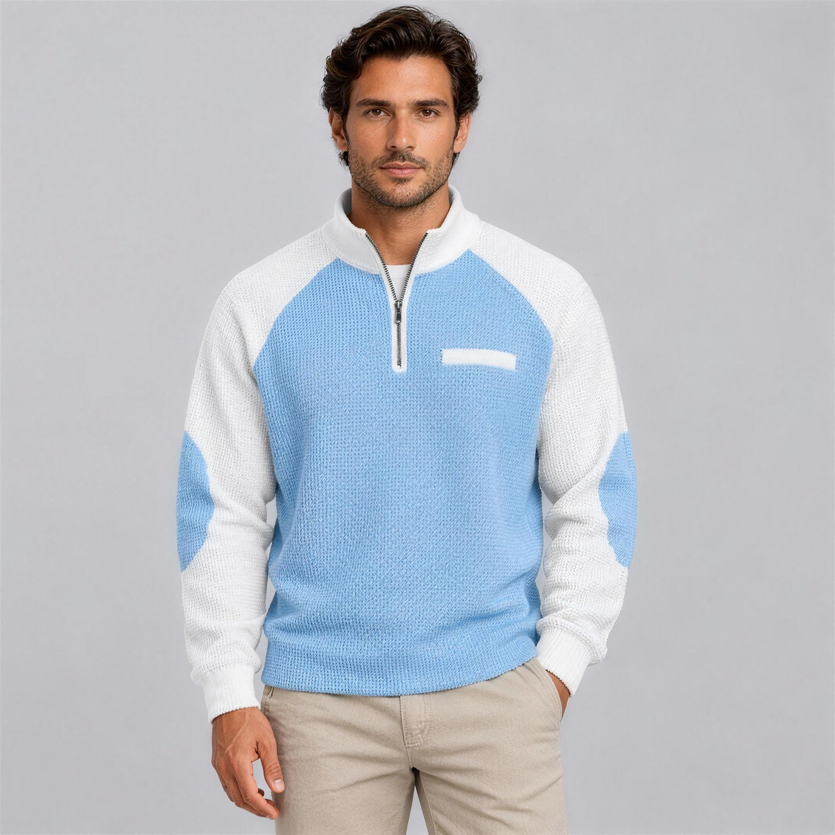 Man wearing the light blue waffle knit quarter-zip pullover with chinos, studio photo